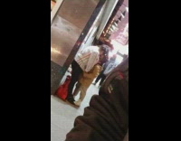 Couple makes out of the sidewalk, girl taller than guy