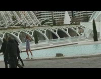 Woman in blue dress weird dance by the fountain