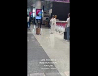 Woman white outfit tiktok dance at airport