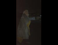 Woman covered with blanket plays red light green light