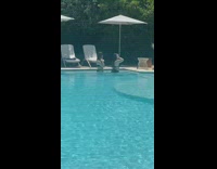 Two girls black bikini dance in pool