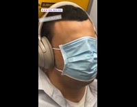 Guy face mask covers face subway train 
