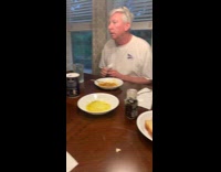 Kid does cup song at dining table