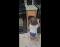 Baby comes out of cabinet 