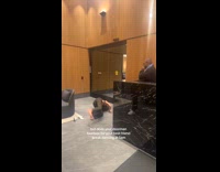 Woman breakdancing while concierge beatboxes