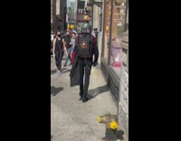 Guy wears boba fett helmet and cape 