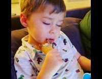 Boy falls asleep while eating ice cream