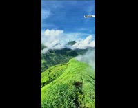 View from grass mountain top fog clouds
