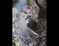 Man jumps and dives inside the cave water