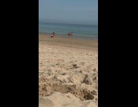 Man shirtless handstand walk beach photo shoot