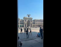 Three women dances in front of cathedral