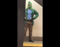 Guy has green shark mask dancing