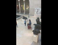 Three girls mimic bears statue pose museum 