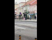Black skirt girl poses by starbucks sidewalk 