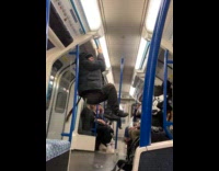Homeless guy pull ups at subway handrails