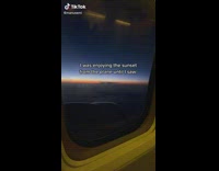 Little foot in corner of airplane seat in front of filmer