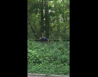 Guy lays back on log lifts rocks 