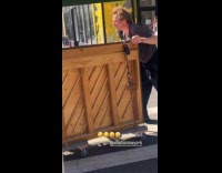 Collab WINY - Man pushes piano on wheels at street