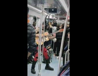 Horny rock metal guy on subway playing the guitar