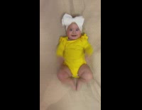 Baby waves her hands and feet in excitement 