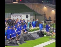 Guy cartwheel on stage at graduation ceremony