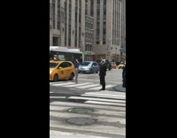Girl in street cars driving by close traffic blue jacket