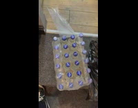 Fingernails open the plastic package of the water bottles