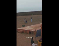 Woman in white outfit models and poses on the rooftop