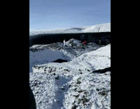 Woman white pants stand on snow mountain