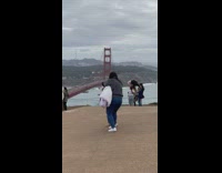 Woman in black top balanced on the log barrier