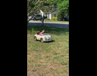 Baby sleeps on wheel in toy car