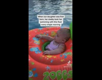 Dad Swims with Baby on Floaty Ring