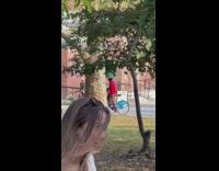 Guy bikes with green trashcan on his head