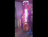 Guy sits on arcade game testing strength 