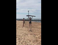 Beach guy lunges carry driftwood