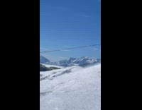 Guy ski on mountain gets very windy