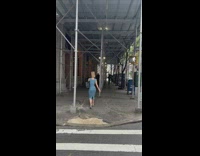 Woman walks with paper bag on her head