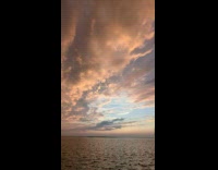 Orange and blue sky at sunset at the beach park