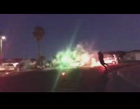 kids playing in street with red and green fire works
