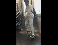 Guy sweatpants does robot dance on subway train