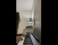 Girl plays piano song in room