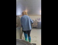 Woman carries two puppies for bath time