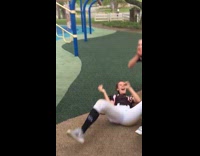 Softball Girl Slides Down Blue Playground Equipment and Falls On Face