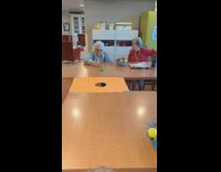 Old woman roll and shoot balls into hole