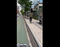 Collab WINY - Man ride bike balance tire on head jogger on the sidewalk