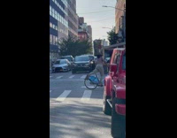 Biker with garbage can on head leg out 