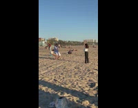 Woman in white top raise hands on the beach