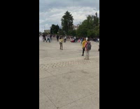 Girl dances middle of busy plaza