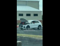 Employees at dealership fixing car 
