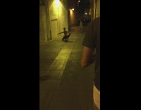 Shirtless guy rolls on alley ground 